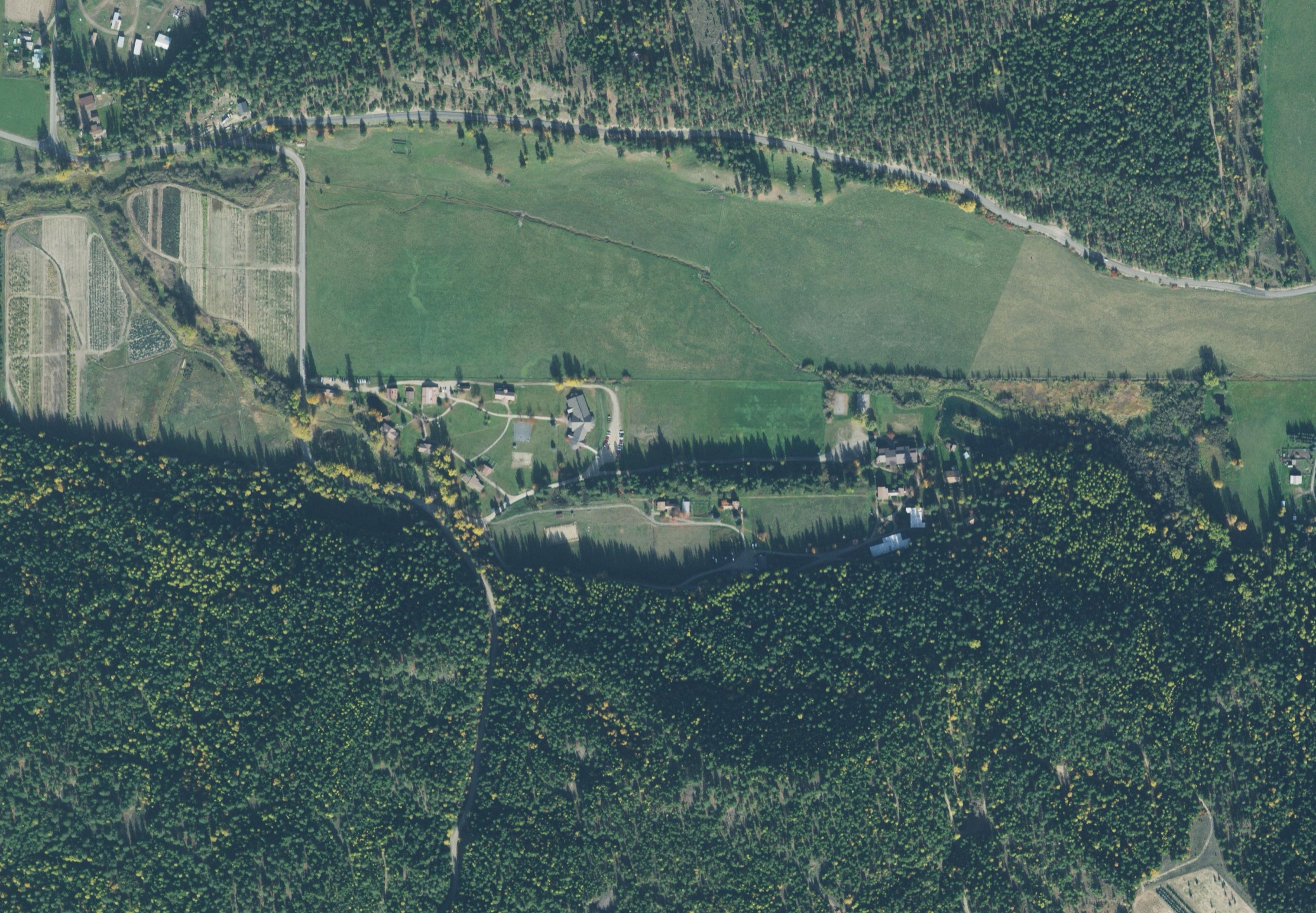 Aerial photo of the lower campus with the barn and the parking lot marked